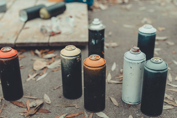 istock cans with colorful spray paint for graffiti on asphalt 966243068