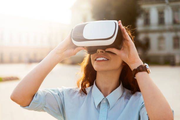 istock Girl is trying virtual reality headset outside 966247380
