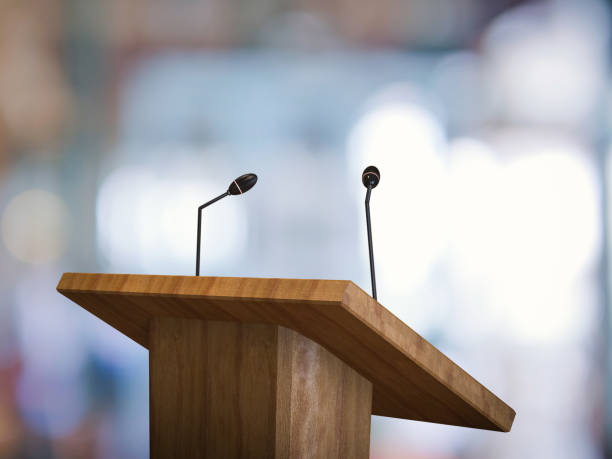 podium with microphone 3d rendering wooden podium with microphone on blurred background lectern stock pictures, royalty-free photos & images