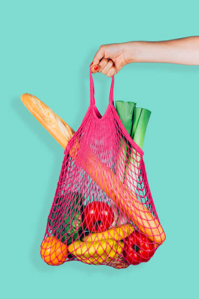 Retro and ecological string shopping bag in woman hand
