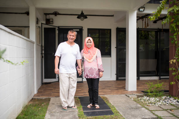 istock Senior couple standing in the front or back yard 966254312