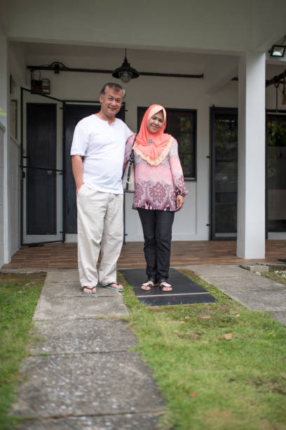 istock Senior couple standing in the front or back yard 966256184