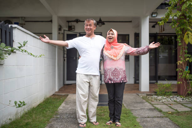istock Senior couple standing in the front or back yard 966256512