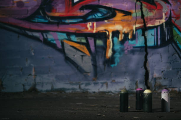 istock colorful graffiti on wall cans with aerosol paint standing on foreground 966256856