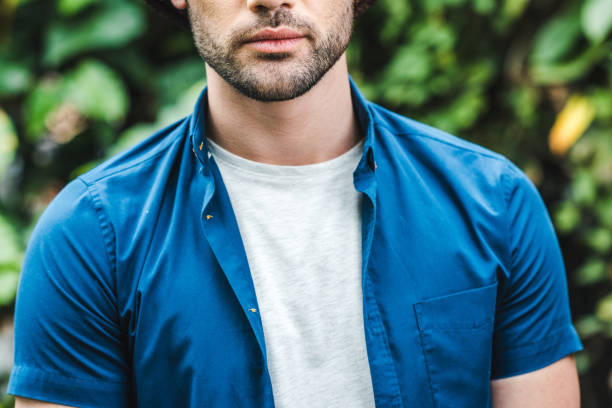 istock cropped shot of handsome young man with blurred leaves on background 966257576