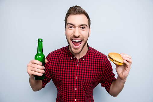 Yeah yes achievement hooray chant alcohol sandwich entertainment rejoice people person concept. Close up portrait of excited surprised glad yelling fan watching final on tv isolated on gray background