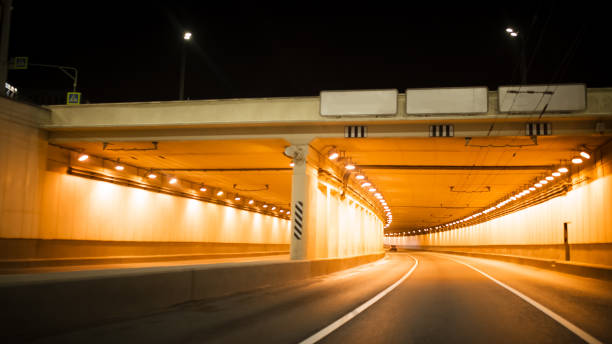 istock Road bridge subway underground tunnel illuminated at night city lights 966261426