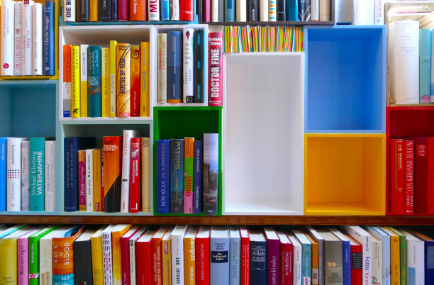 istock Library with many books and empy colorful shelfs 966267692