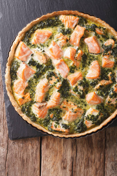 istock pie with salmon, cream and spinach in baking dish close up. vertical top view 966273138