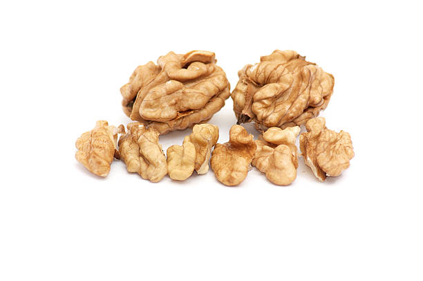 istock Pieces of walnuts on a white. 96627438