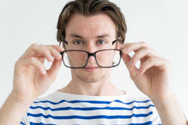 istock Confident purposeful man holding glasses and looking through it 966280986