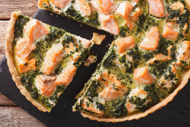 istock Tasty sliced Savory quiche with salmon and spinach, close-up. Horizontal top view 966284032