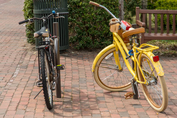 istock Yellow and black bicycle lock to a post 966284690