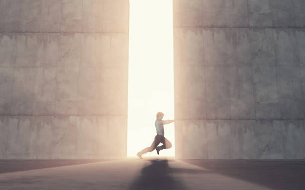 istock Young man pushing a big door. 966285732