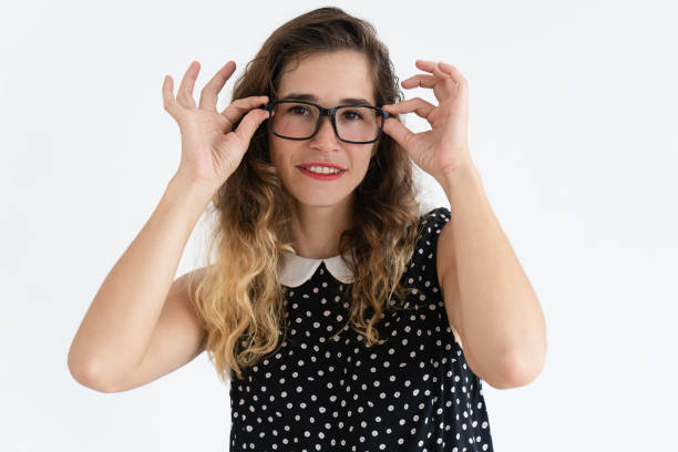 istock Smiling young pretty woman adjusting glasses with both hands 966290554