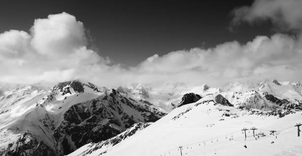 istock Panoramic view on ski slope and cloudy mountains at nice sun day 966294666