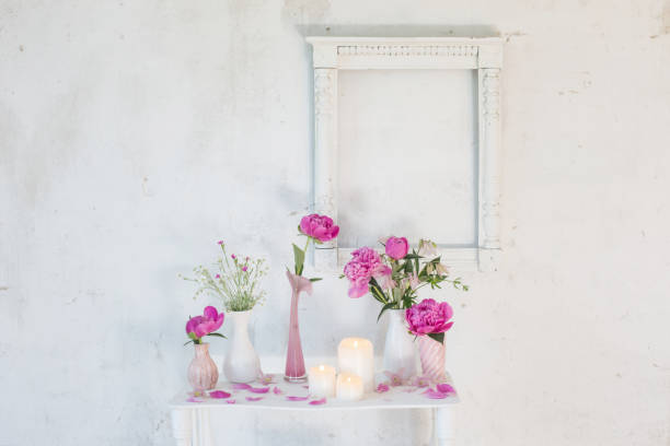 istock flowers in vases and candles on white background 966294812