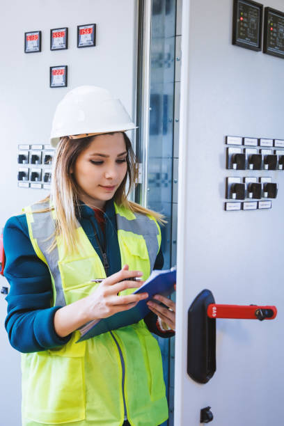 istock Female stationary engineer take notes at energy control room 966298554
