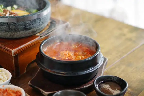 Photo of Kimchi Tofu Soup served in clay pot.