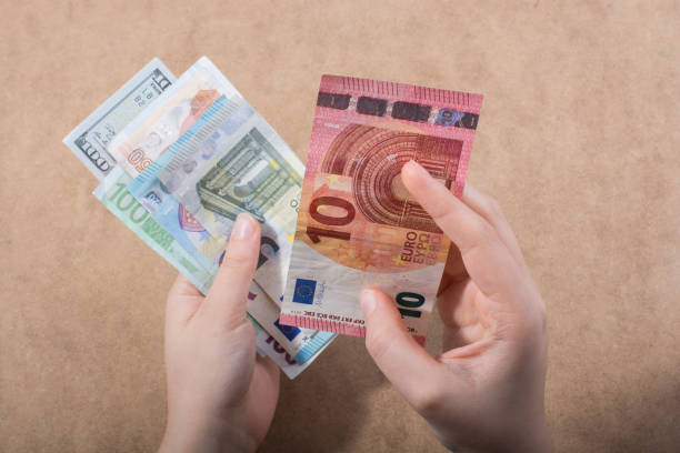 istock Hand holding American dollar  isolated on wooden background 966306954