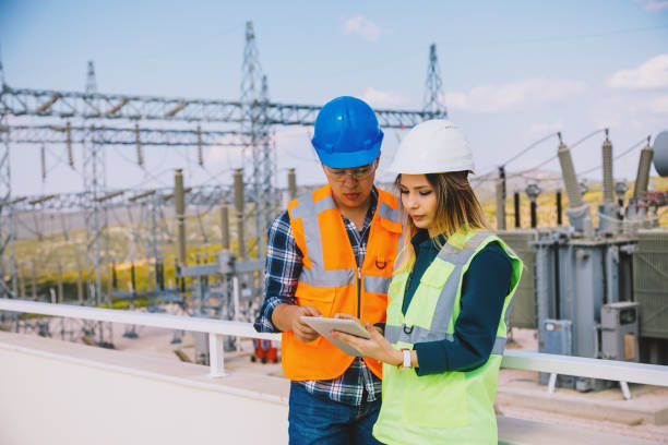 istock Young workers looking and checking wind turbines at field 966307248