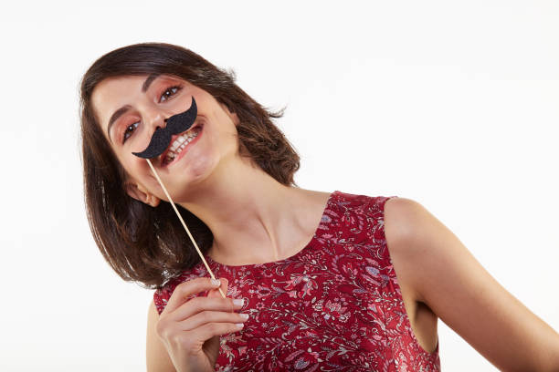 cute and beauty young woman with party mask - costume mustache child disguise imagens e fotografias de stock