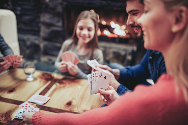 Young family playing card game Young family playing card game at home family playing card game stock pictures, royalty-free photos & images