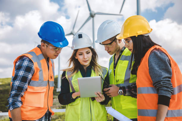 istock Young engineers and workers having a meeting at wind farm 966315434