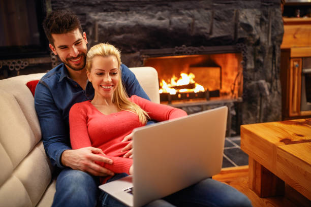 istock Smiling couple with laptop spending time together 966317840