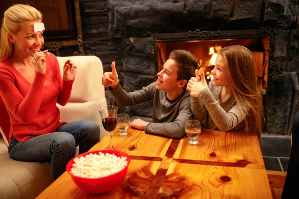 istock Happy mother playing game with children 966323816