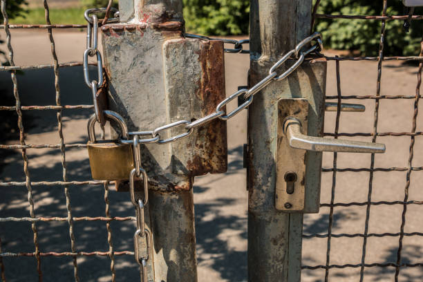 istock Closed gate with big steel chain and padlock 966326468