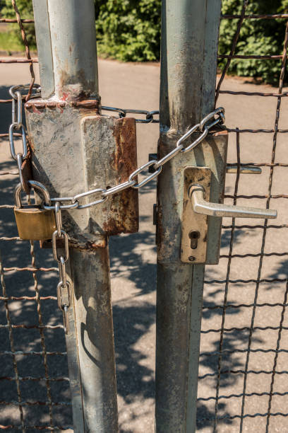 istock Closed gate with big steel chain and padlock 966326674