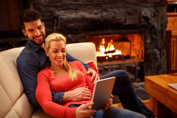 istock Young happy couple in love using tablet together 966327332