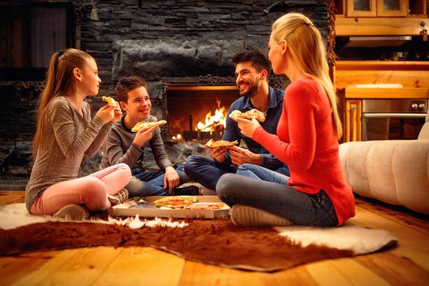 istock Family have fun and eating pizza together 966327434