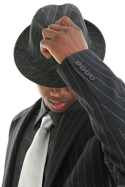 istock Attractive Young Man In Pinstripe Suit Tipping His Hat 96632790