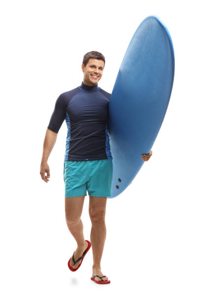 istock Surfer holding a surfboard and walking towards the camera 966332152