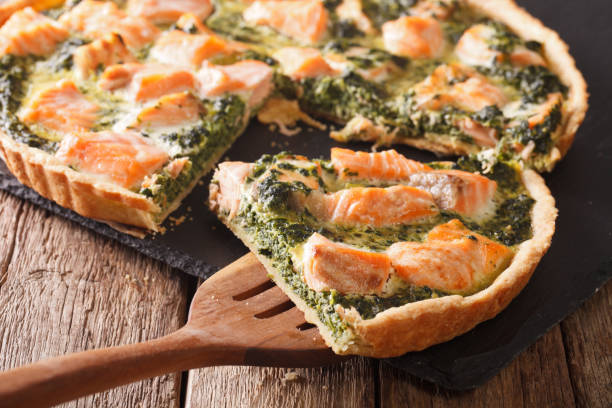 istock Sliced tart with salmon, spinach and cream close-up. horizontal 966335522
