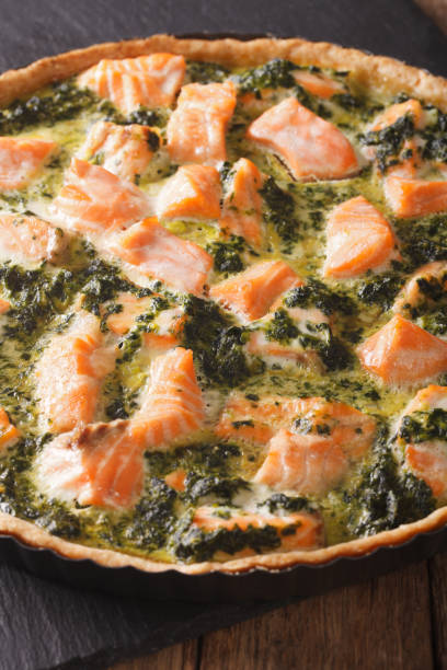 istock Healthy Savory quiche with salmon and spinach in dish macro. Vertical 966335602