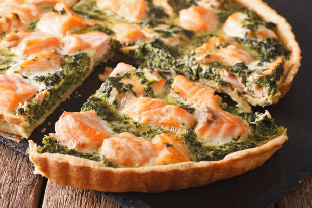 istock Savory food: sliced tart with salmon, spinach and cream close-up. horizontal 966338354