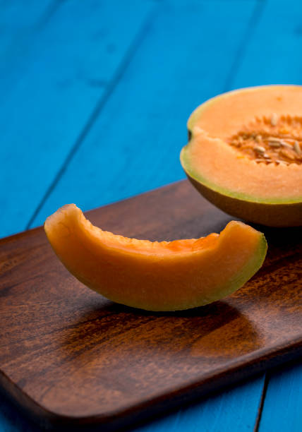 plasterek muskmelon na drewnianym tle - melon watermelon cantaloupe portion zdjęcia i obrazy z banku zdjęć