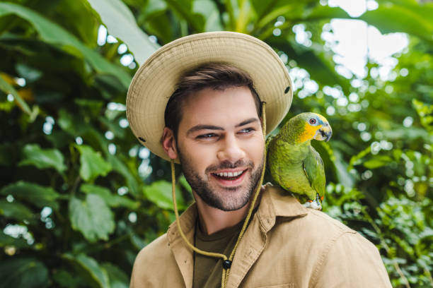 istock handsome young man with parrot on shoulder 966346470