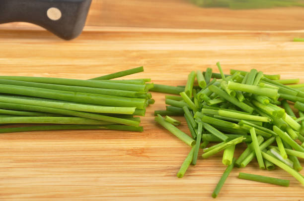 istock Chives with table knife and cutting board isolated 966346746