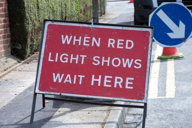 istock UK road sign. When red light shows wait here. 966350758