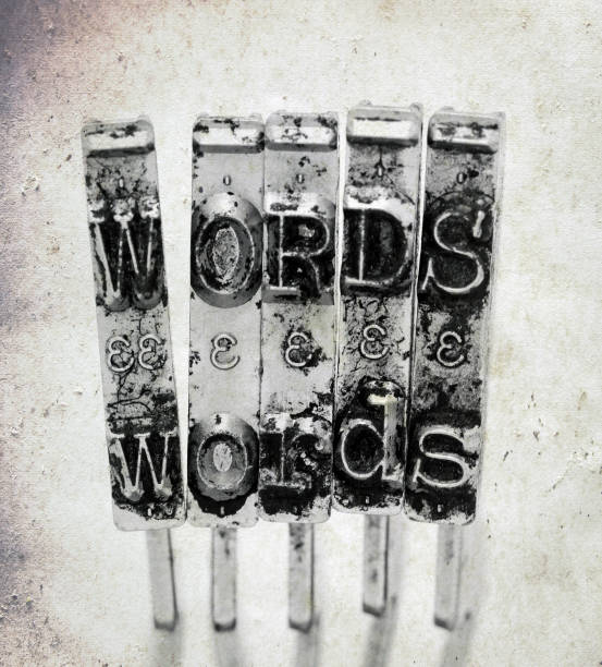 The word  WORDS  with old typewriter hammers  with old paper background macro image