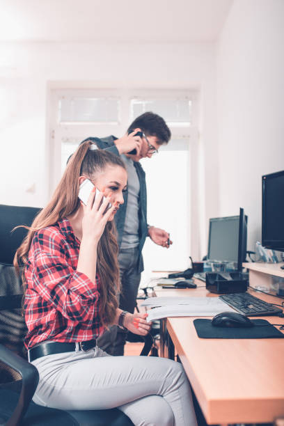 istock Colleagues talking over mobile phone 966359928