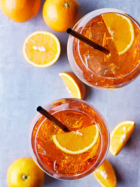 Two glasses of Spritz cocktail with orange slices on marble background. Top view