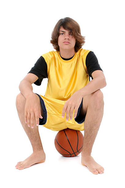 istock Boy Teen Sitting On Basket Ball Over White 96636716