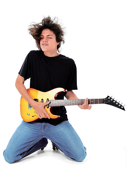 istock Barefoot Teen Playing Electric Guitar Over White 96636795