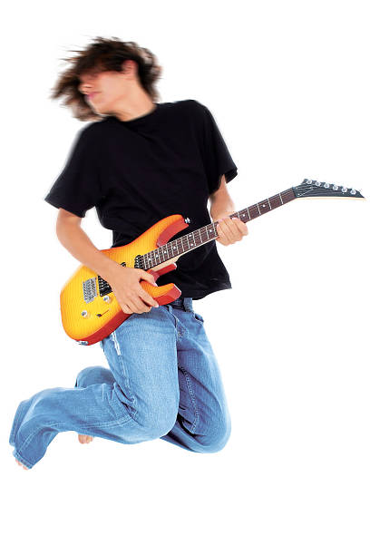 istock Boy Jumping With Electric Guitar Over White 96636857