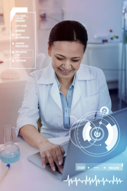 istock Cheerful scientist smiling while working on the laptop 966368690